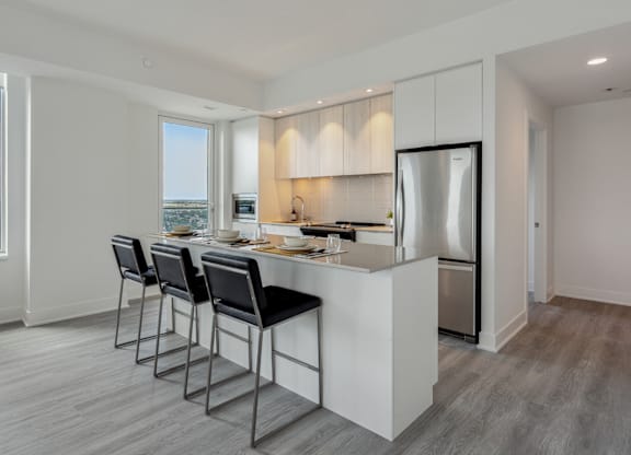 A modern kitchen with a large island and stainless steel appliances.