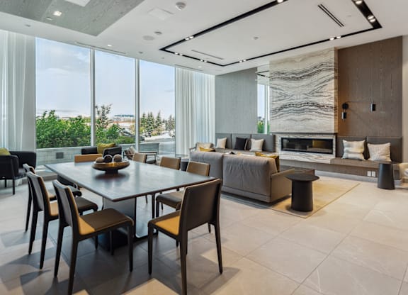 A modern dining room with a large table and chairs.
