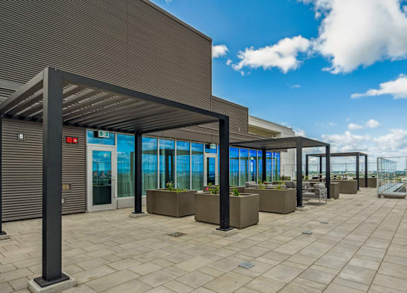 A modern building with a glass facade and a covered walkway.