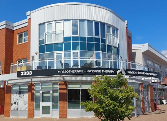 A building with a sign that reads "3333 Mossotherapy Massage Therapy".