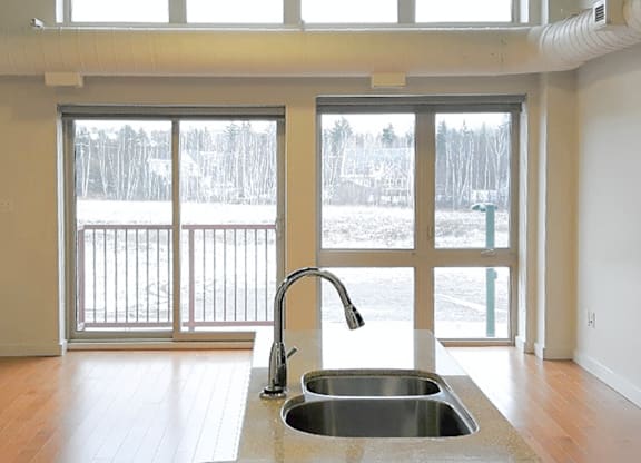 A kitchen sink with a faucet and a countertop.