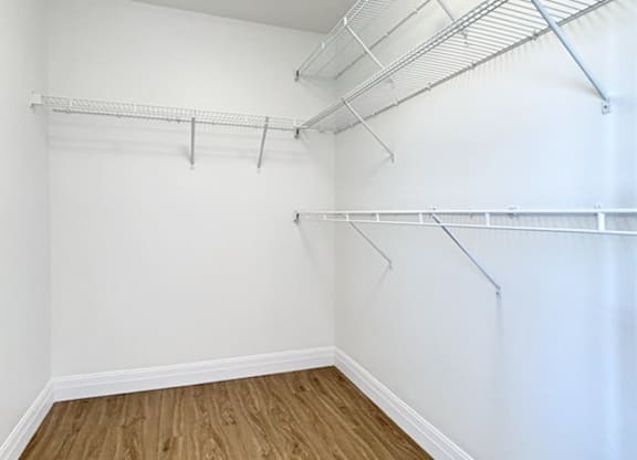 Empty room with white walls and wooden floor.