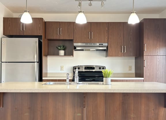 A kitchen with wooden cabinets and a white countertop.