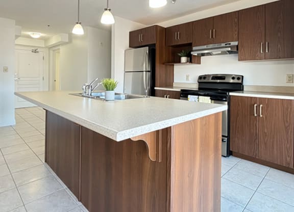 A kitchen with a white countertop and brown cabinets.