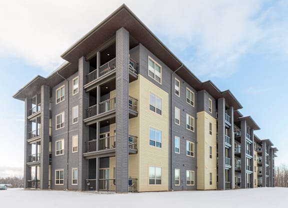A large apartment building with balconies and multiple stories.