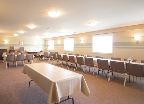A conference room with a long table and chairs.