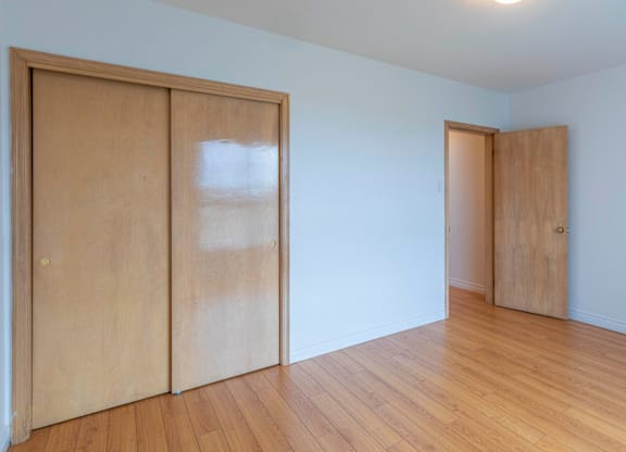 A room with two wooden doors and a light on the ceiling.
