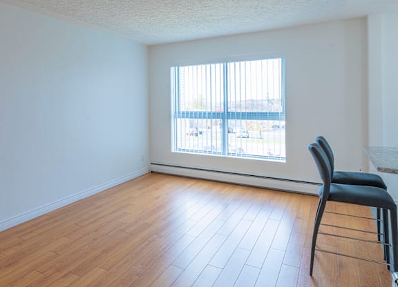 A room with a chair and a window.