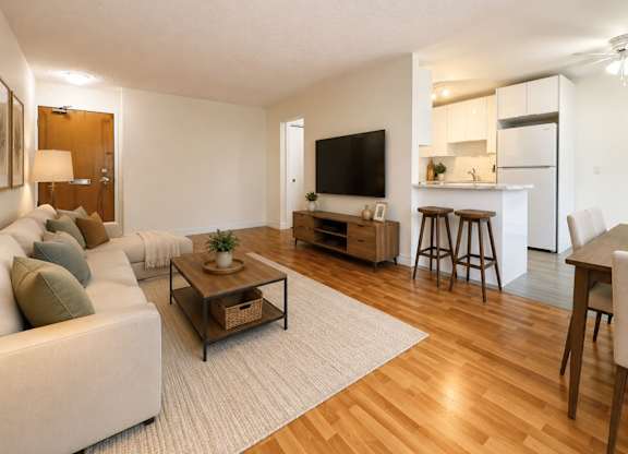 A living room with a white couch and a wooden coffee table.