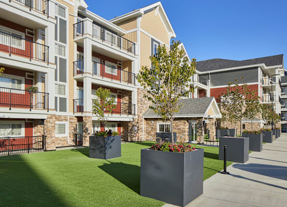 Apartment complex with a green lawn in front.