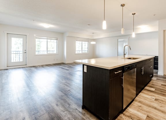 A kitchen with a large island and stainless steel appliances.