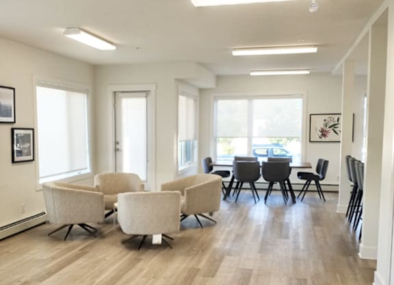 A room with a table and chairs.