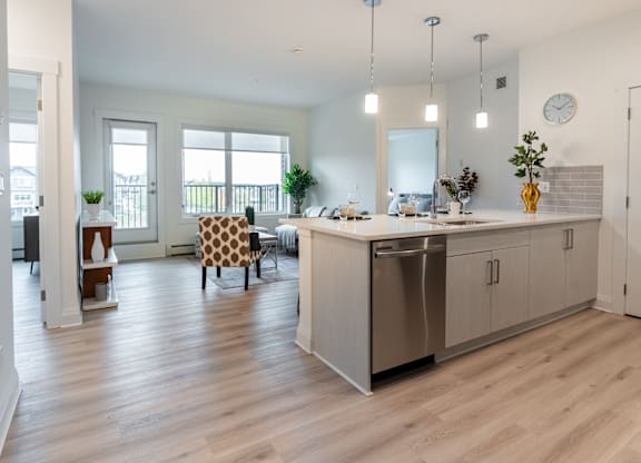 A modern kitchen with a dining table and chairs.