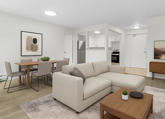 A modern living room with a beige sofa, a wooden coffee table, and a dining table with chairs.