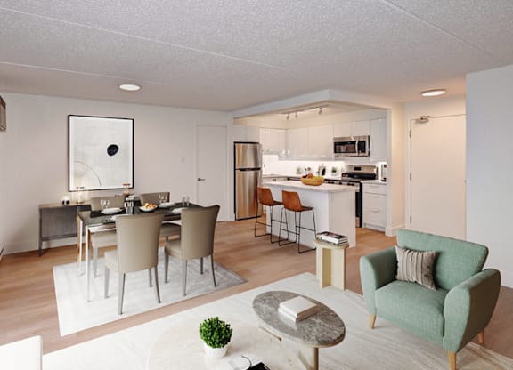 A modern living room with a dining area and kitchen in the background.