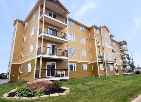 A large apartment building with a balcony on the second floor.