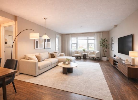 A modern living room with a large sectional sofa, a coffee table, and a flat-screen TV.