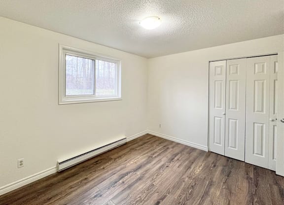 A room with a window and a door.