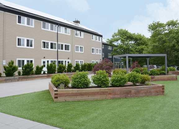 A building with a green lawn in front of it.