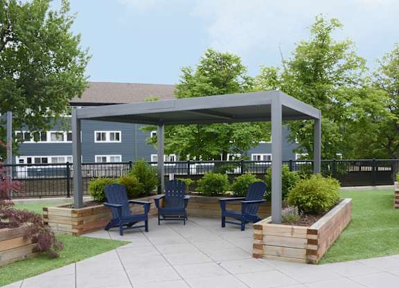 A patio with a table and chairs under a canopy.