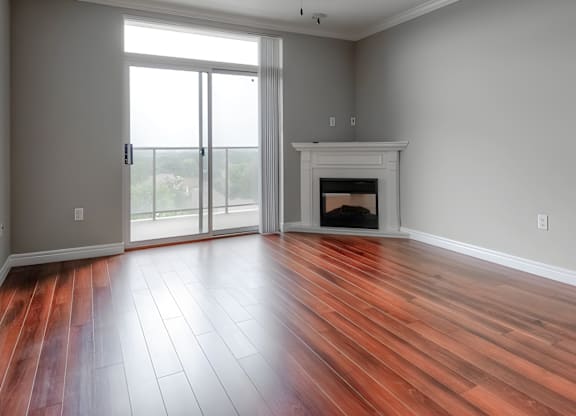 A room with a fireplace and sliding glass doors.