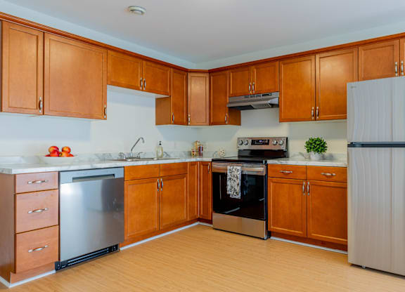 A kitchen with wooden cabinets and a white refrigerator.