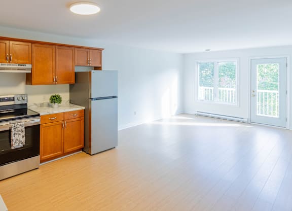 A kitchen with wooden cabinets and a refrigerator.