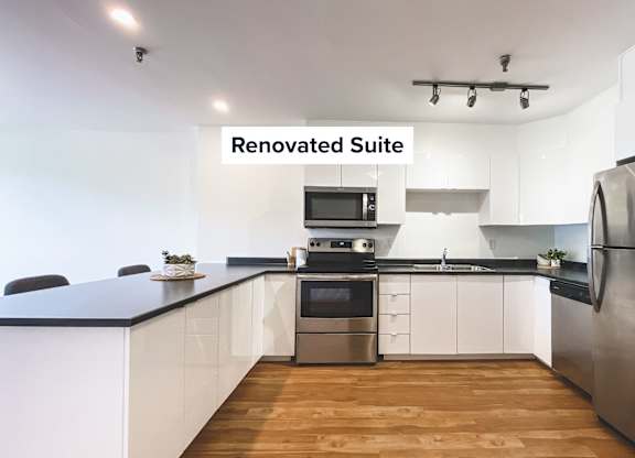 A renovated suite with a kitchen and dining area.