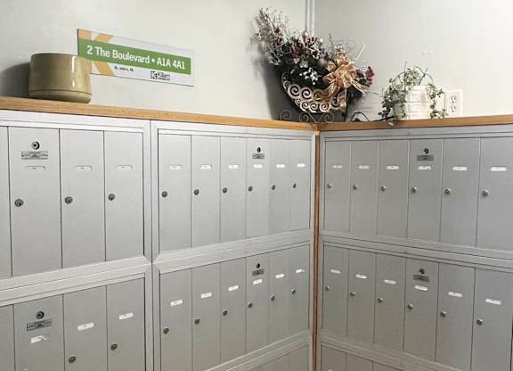 A wall of grey lockers with a sign above them that reads "2 The Boulevard A14 441".