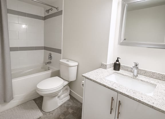 A white toilet sits next to a sink in a bathroom.