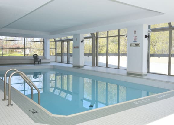 A large indoor swimming pool with a sign that says "JEEP AREA" on the wall.