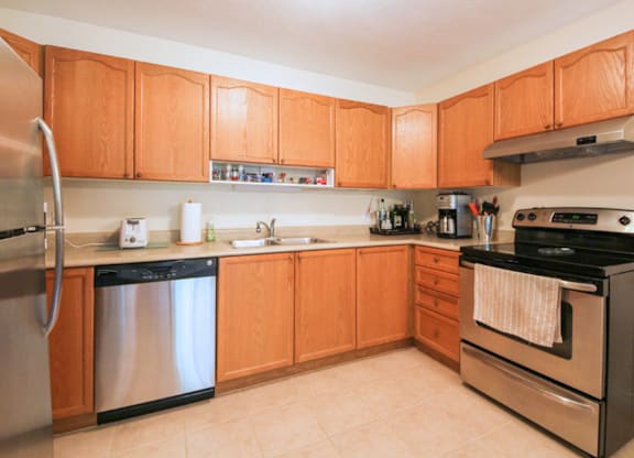 A kitchen with wooden cabinets and stainless steel appliances.