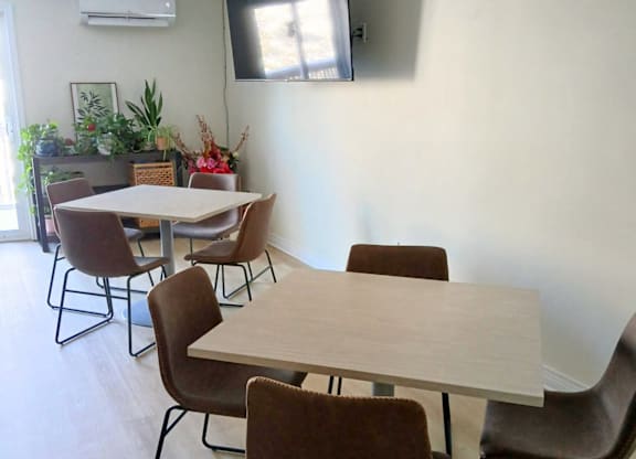 A conference room with a long table and chairs.
