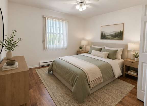 A bedroom with a large bed and a ceiling fan.