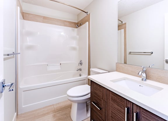 A white toilet sits next to a sink in a bathroom.