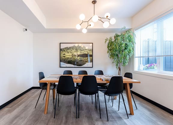 A dining room with a wooden table and chairs.