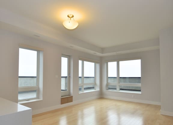 A large empty room with wooden floors and white walls.