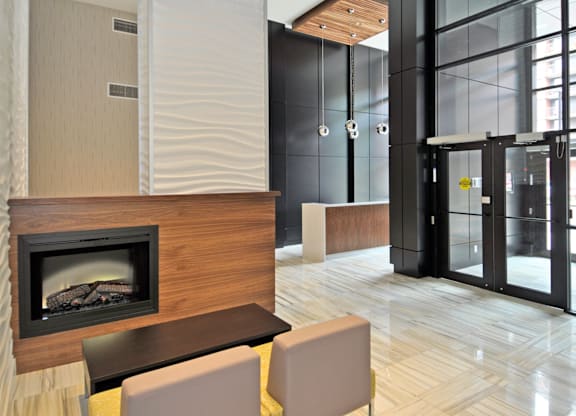 A modern living room with a fireplace and a glass door.