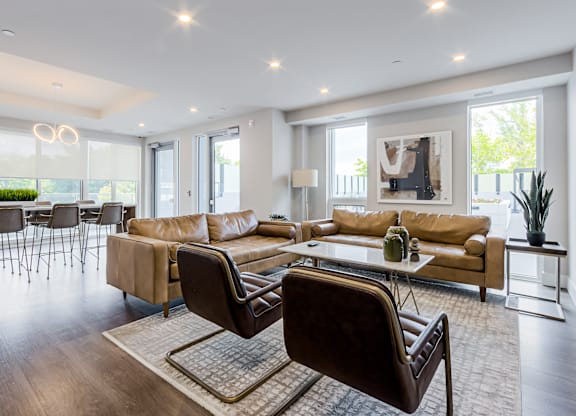 A modern living room with a brown leather chair in the foreground.