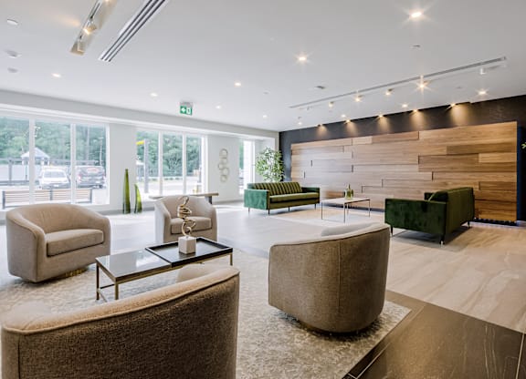A modern living room with a glass table and comfortable seating.