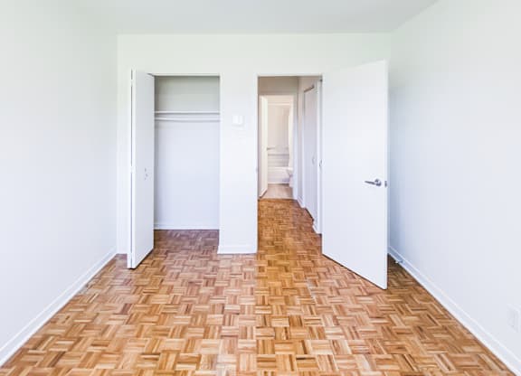A room with a wooden floor and white walls.