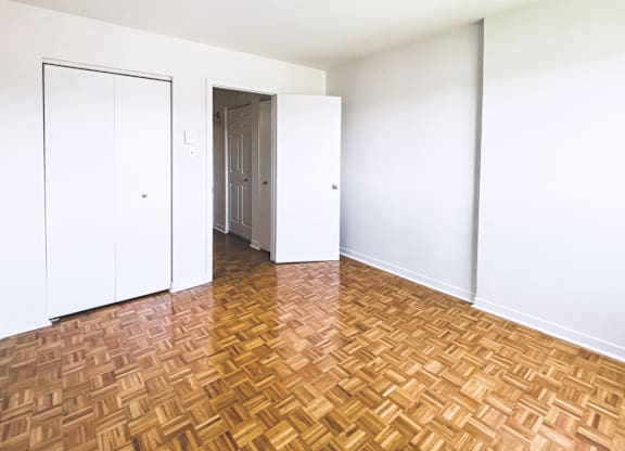 A room with a wooden floor and white walls.