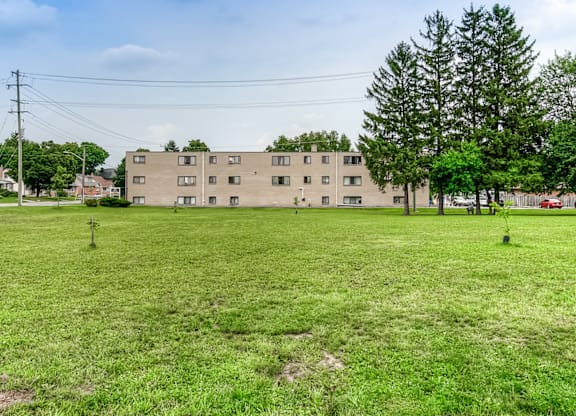 A grassy field with a building in the background.
