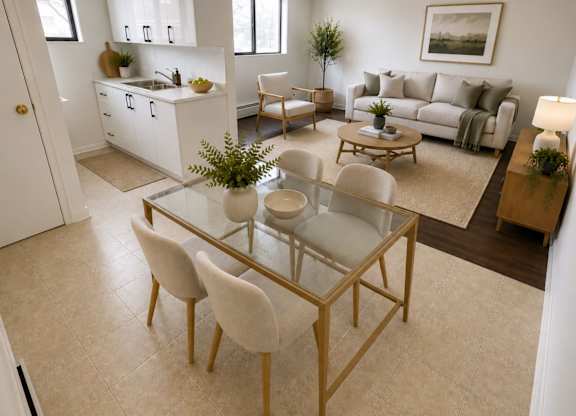 A modern living room with a glass table and white chairs.