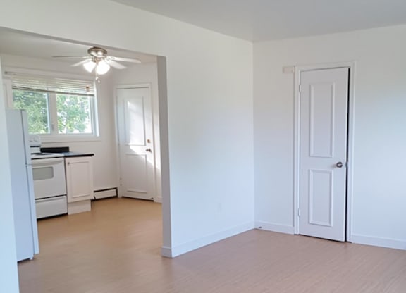 A white room with a door and a window.