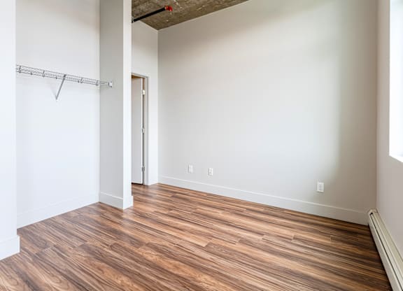 A room with a wooden floor and a ceiling fan.