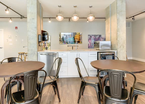 A modern kitchen with a dining table and chairs.