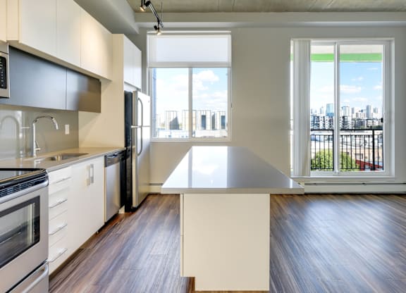 A modern kitchen with a large island in the middle.