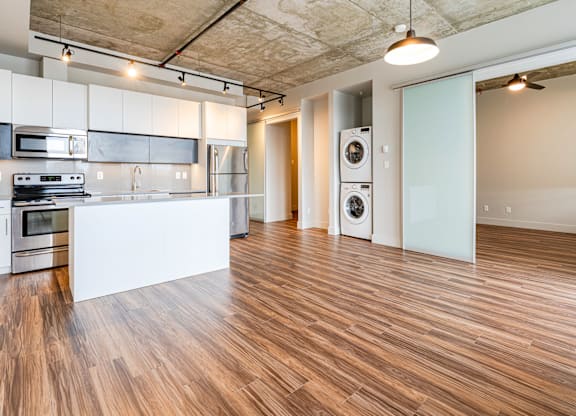 A kitchen with a white countertop and stainless steel appliances.