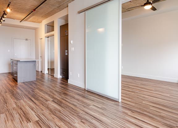 A room with a wooden floor and a white wall.